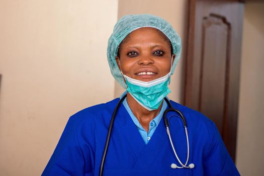 a young nurse standing with a stethoscope and a medical hat smiling at the camera.