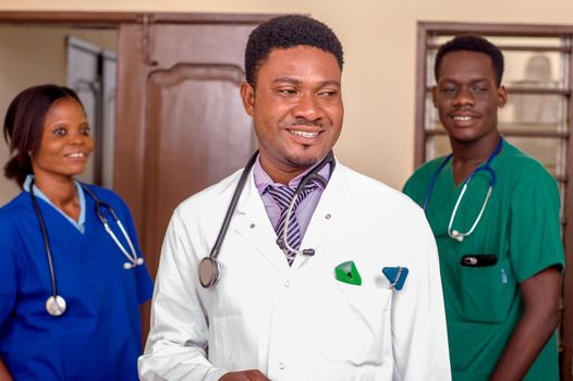 a team of doctors standing in a room ready for work.