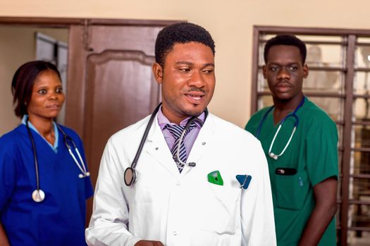 a team of doctors standing in a room ready for work.