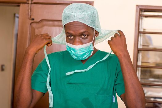 portrait of standing upright doctor wearing his work equipment.