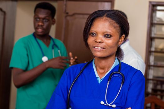 group of happy doctors with stethoscopes or a mentor with trainees standing in hospital