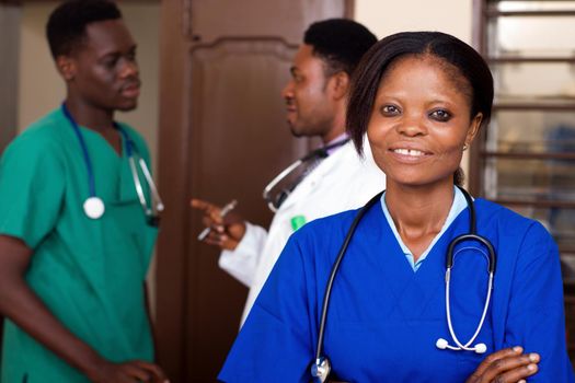 group of happy doctors with stethoscopes or a mentor with trainees standing in hospital