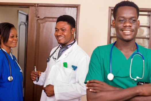 group of happy doctors with stethoscopes or a mentor with trainees standing in hospital