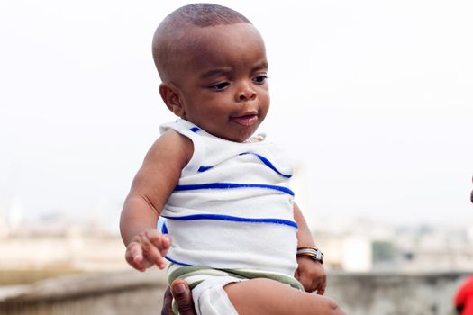 portrait of a pretty baby raised by someone.