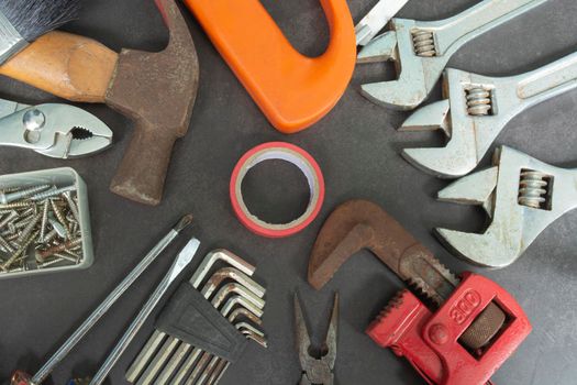 Repair equipment and many handy tools on a dark background. Labor day concept