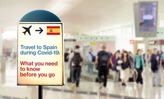 a signal inside an airport that warns about what to know before flying to Spain during the Covid-19 pandemic. Airport security measures and travel restrictions. New Delta variant spread