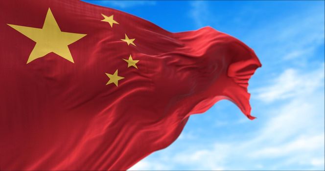 The national flag of People's Republic of China flying in the wind. Outdoors and sky in the background.