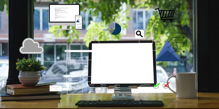 Mockup image of a black tablet with white blank screen on wooden desk