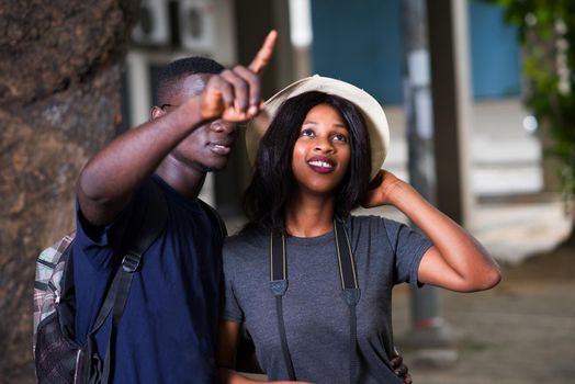 Tourist couple traveling and using the map. man points to a place to explore