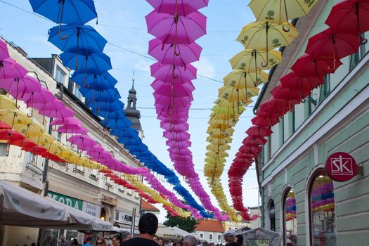 Different colours hanging umbrellas on Porcijunkulovo 2019