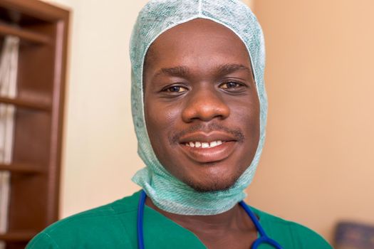 young doctor with stethoscope at the court wearing a medical hat and smiling at the camera.