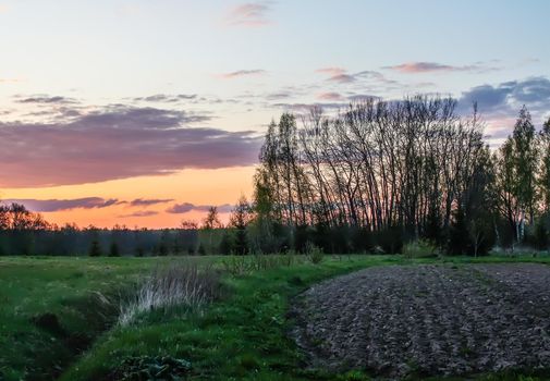 Spring landscape in the countryside. Beautiful sunset in april.